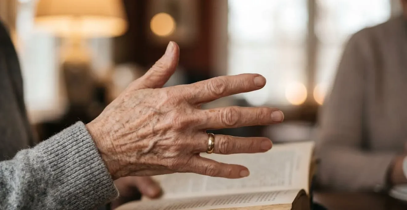 Close-up of senior hands gesturing during animated book discussion with blurred conversation partner