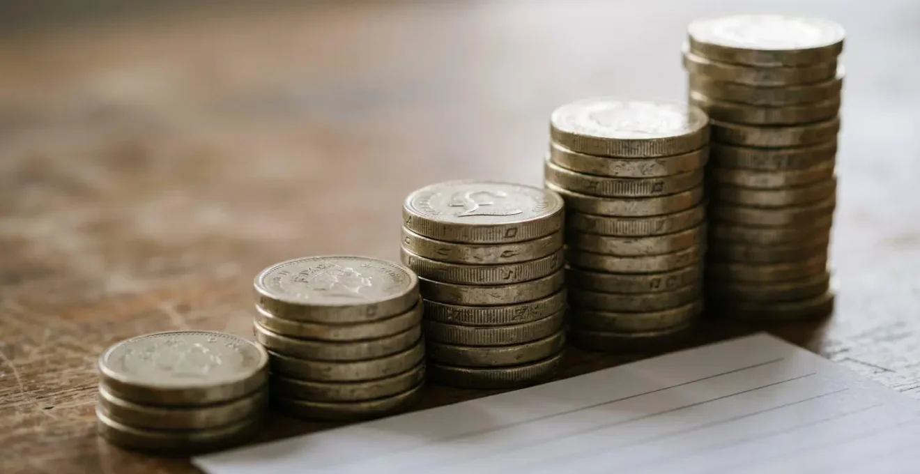 Stacked coins with upward growth pattern representing healthcare cost inflation and savings planning