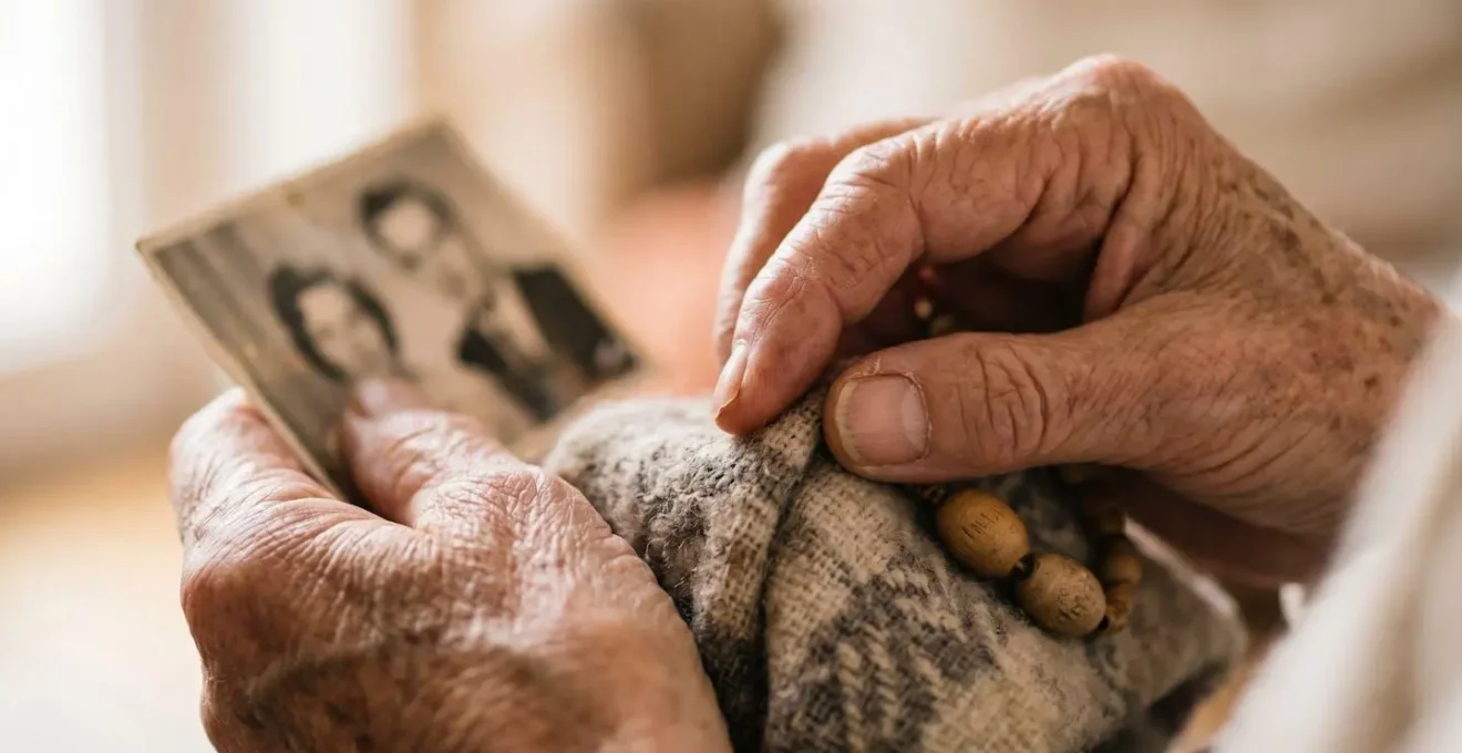 Close-up of hands documenting individual care preferences with attention to personal details in natural care home setting